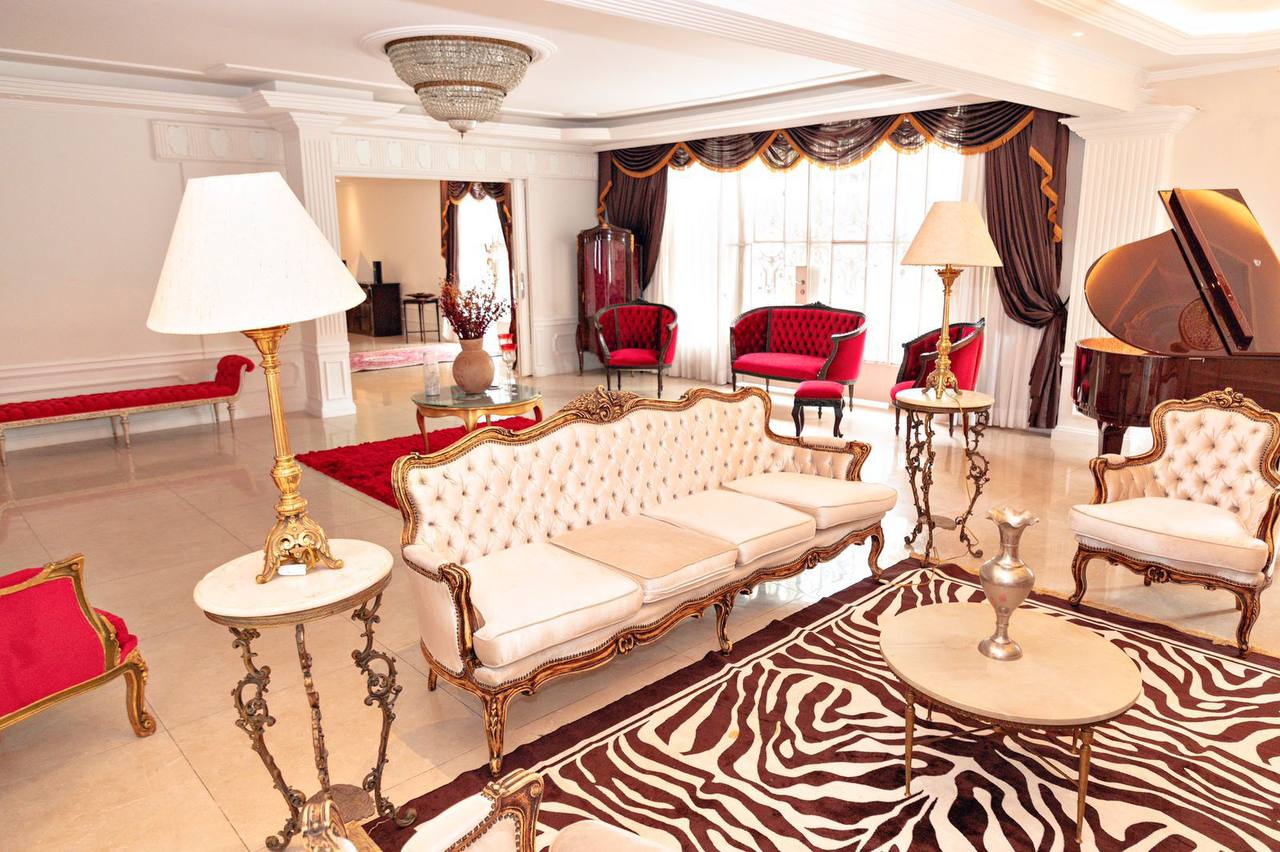 Elegant luxury sitting room with ornate furniture and piano.